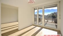 Empty room with sliding doors to a balcony and a view of mountains