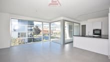 Open kitchen, glass doors leading to terrace, large windows, tiled floor