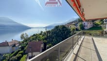 First or second home residence, balcony with glass railing, view of mountains and lake