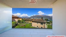 large glass wall, balcony, tiled floor, view of mountains and houses