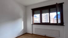empty room, wooden floor, white walls, large window, radiator, open window