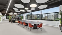 large meeting room with long table, large windows, modern lighting, plants, carpet floor