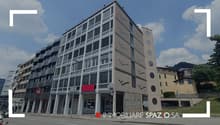The building features modern architecture, multiple floors, large windows, and a flat facade.
