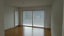 empty room, white walls, wooden floor, large sliding glass doors