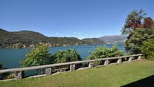 Green lawn, lake in background, mountains