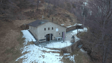 Mountain house, raised ground floor, solar panels on the roof, covered porch, garden, surrounded by trees