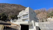 modern apartment building with multiple balconies and underground garage