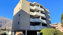 modern apartment building, balconies, 4 stories, basement parking, concrete balcony structures