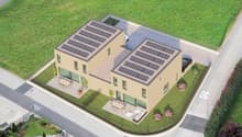 Two story building with solar panels on the roof, car park and seating area