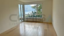 soggiorno-pranzo vista lago / Wohn- und Essbereich mit Seeblick / Living/Dining Room with Lake View