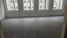 Empty room with 3 windows, concrete floor