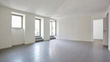 Empty room, tile floor, 2 windows, doorways
