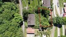 House on elevated plot, surrounded by trees, pool in the corner