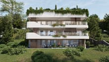 3-story modern apartment building with white exterior, large balconies, and lush greenery on the roof and surrounding the building. The building has a sleek, contemporary design with wooden accents and large windows.