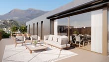 Outdoor seating area with a white rug, a wooden coffee table, and cushioned chairs and a sofa. There is also a dining table and chairs for indoor dining, both covered with white curtains. There are windows allowing for views of the outside.