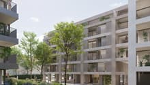Modern residential apartment complex, concrete walls, large windows, multiple balconies, greenery, ground floor entrance