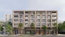 Multi-story residential building, large windows, balconies, modern design, elevated ground floor, concrete exterior