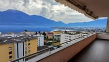 Balcony, tiled floor, railing, surrounding buildings, city view, lake view, mountain view