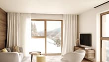 neutral color scheme, large windows, couch, armchair, coffee table, TV, wooden entertainment center, rug
