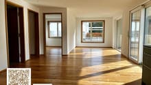 Open room, hardwood floors, two doors, double windows, sliding doors, balconies, view of trees