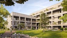 Multi-story apartment building with balconies, surrounded by trees and greenery, with a landscaped courtyard and children playing in the foreground.