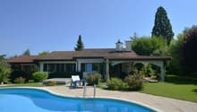 Modern house with swimming pool, outdoor seating, well-kept garden