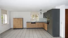 kitchen with wooden cabinets, sink, dishwasher, tile floor, and window with white blinds
