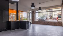 modern kitchen with black cabinets, countertop, sink, faucet, large windows, tiled floor, hanging lamps