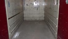 Empty garage space with two metal doors