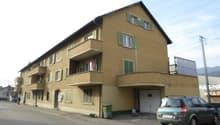 3 story house, beige paint, balconies, garage
