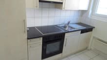 modern kitchen with white cabinets, black countertops, electric stove, oven, sink, dishwasher, and a window