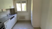 modern kitchen with white cabinets, tiled floor, sink, dishwasher, oven, window, radiator