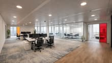 open office space, modern office furniture, office tables, chairs, glass walls, glass doors, plants
