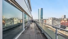 Balcony with benches, glass walls, city view