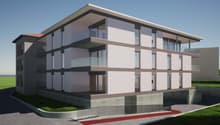 3-story modern apartment building with a flat roof, large windows, and a balcony on the upper floors. The building has a clean, minimalist design with a combination of light and dark colors.