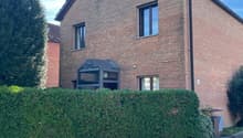 2 story house, brick exterior, 3 windows, glass doors, chimney