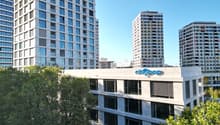 Tall modern high-rise buildings with glass facades, surrounded by trees. The building in the foreground has the 'Citypop' logo on it.