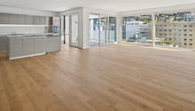 Open floor plan, modern kitchen, hardwood floors, kitchen island, glass sliding doors, balconies, panoramic city view