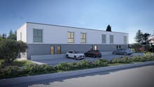 modern 2-story building, white exterior, gray accent, large windows, driveway with three cars parked, surrounding landscaping