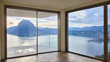 large glass windows, wooden floor, open balcony, view of lake and mountains