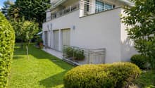 2 story house, white exterior, balcony, garage, garden, trees