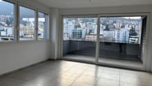 empty room, sliding glass door to balcony, tile flooring, windows, balcony with view