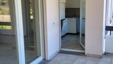 empty balcony with large glass sliding doors, tile flooring, leading to kitchen