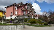 3 story house, pink and white exterior, balconies, garage, garden, street view