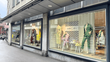 A building with a shop on the ground floor, glass windows, and a signboard with the text 'MARCAIN'.