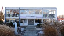 2 story building, modern glass windows, signage reading "Wunschräume.ch"