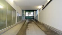 concrete floor, white walls, glass panels, lights on the ceiling
