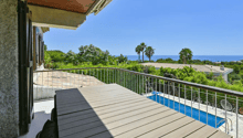 wooden terrace, metal railing, wooden table, swimming pool, sea view
