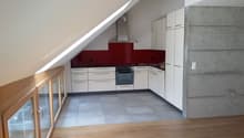 modern kitchen, white cabinets, red wall, gray floor, stainless steel appliances