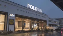 Polipark building, modern architecture, large windows, parking area, signboard, car parked
